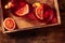 Negroni cocktail with blood oranges, overhead shot on a wooden background