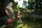 A neighbor looks over the fence at her friends who are in her rural backyard.