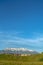 Neighborhood on a hill with amazing view of snow peaked mountain and blue sky