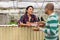 Neighbors have a conversation in greenhouse