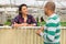 Neighbors have a conversation in greenhouse