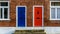 Neighbouring Terraced Houses With One Blue And One Red Front Door A