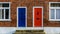 Neighbouring Terraced Houses With One Blue And One Red Front Door B