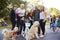 Neighbours with pet dogs smiling to camera at a block party