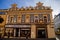 Neo-Renaissance building of the former pharmacy with sgraffito mural decorated plaster in Kladno in sunny day, Narrow picturesque