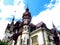 Neo-Renaissance Peles Castle, close-up, on a background of blue sky. Tourist Transylvanian attraction in the Carpathian Mountains