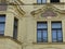 Neoclassic style paintings over the windows  of an ancient building of Prague in Czech Republic.