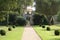 Neoclassical arched entrance, path, and topiary