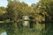 Neoclassical white monument reflecting on lake