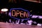 Neon 24 hours open logo sign glowing in the bar store f