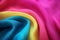 Neon colour silk satin wave drapery pink blue yellow abstract background