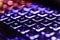 Neon computer keyboard with color backlight. Computer video games, hacking, technology, internet concept. Selected focus