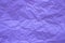 Neon fashionable texture of crumpled paper. Crumpled purple paper