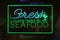 Neon Fresh Seafood Sign in Rainy Window