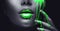 Neon green paint smudges drips from the face lips and hand, green liquid drops on beautiful model girl`s mouth