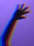 Neon hand with fingers apart. Neon high five on purple background
