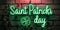 neon illuminated banner text Saint Patrick's day with four leaf clover on a brick wall, poster