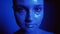 Neon light portrait woman glitter face blue glow