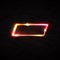 Neon light rectangle led or halogen lamp wall sign on black brick background. Red yellow power glowing bulb banner