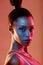 Neon lighting, cyberpunk and portrait of a woman with makeup isolated on a brown studio background. Fashion, futuristic