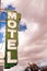 Neon Motel Sign Clear Blue Sky White Billowing Clouds