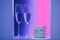 Neon pair of glasses of champagne in the holidays interior