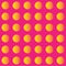 Neon pink background with yellowish orange polka dot pattern