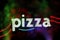 Neon Pizza Sign with colorful bokeh on Restaurant