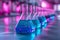 Neon purple glass flask in blue research chemistry or medical lab. Laboratory glassware, test tube and beaker