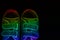 Neon rainbow shoes on black background