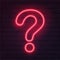 Neon red question mark on dark brick wall. Cinema, show, theatre, circus, casino design. Intellectual signs. Laser diode