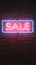 Neon sale sign on brick wall, vibrant urban advertising