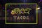 Neon Street Tacos Sign in Wet Rainy Window