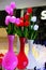 neon vases with tulips in pink, red and white. three lamps with neon illumination in the form of colorful vases with tulips