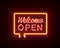 Neon welcome open signboard on the brick wall background.