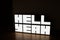 Neon white "Hell Yeah" sign on the table