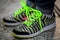 neongreen shoelaces on zebra print sneakers worn by a teenager