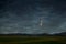 Neowise comet over rural mountain landscape