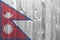 Nepal flag depicted in bright paint colors on old wooden wall. Textured banner on rough background