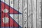 Nepal flag depicted in bright paint colors on old wooden wall. Textured banner on rough background