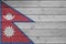 Nepal flag depicted in bright paint colors on old wooden wall. Textured banner on rough background