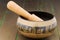 Nepal singing bowl on a wooden gold painted surface.