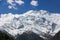 Nepal snowy mountains against the blue sky with clouds