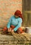 Nepal Woman Kneeling on Stoop and Weaving