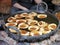 Nepalese bread doughnuts fried in a black dirty pan