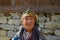 Nepalese elderly woman in traditional attire in the village along Everest Base Camp, Nepal