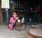 Nepalese little girl in typical Nepalese kitchen