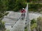 Nepalese man passing suspension bridge on motorbike