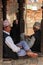 Nepalese men traditionally gather in groups and gossip in the city streets with traditional Nepalese caps