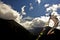 Nepalese prayer flags and a soaring snow capped Annapurna peak and clouds in the background